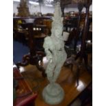 A PAINTED METAL FIGURE OF A FEMALE EASTERN DEITY, on a circular base, painted verdegree finish,