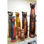 EIGHT STYLIZED WOODEN CAT SCULTPTURES, painted in a variety of colour schemes, the tallest is