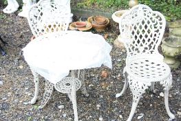 A STONE EFFECT ALUMINUM GARDEN TABLE, two chairs and seat pads (2)