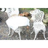A STONE EFFECT ALUMINUM GARDEN TABLE, two chairs and seat pads (2)