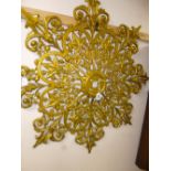 AN EARLY 20TH CENTURY GOLD GLOSSED CAST METAL CEILING FLOWER, issuing twenty four embossed leaves,