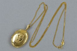A MODERN 9CT GOLD LOCKET, oval shape, half engraved in a fancy scroll design, together with fine
