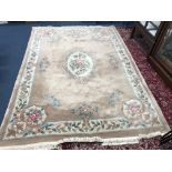 A CHINESE WOOLLEN CARPET SQUARE, brown, green and cream ground with a floral design and central