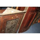 A VICTORIAN BOWFRONT HANGING CORNER CUPBOARD, and an oak hanging corner cupboard with carved panel