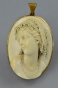 AN OVAL VICTORIAN HIGH-RELIEF WORK IVORY CAMEO, depicting a Bacchante, set within a latter gold