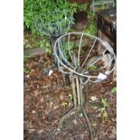 A CAST IRON TABLE BASE, an aluminium copy of the same and two hanging baskets (4)