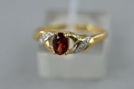 A GARNET AND DIAMOND DRESS RING, ring size Q, approximate gross weight 1.9 grams