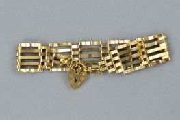 A LATE 20TH CENTURY 9CT GOLD GATE BRACELET, fitted to a padlock and safety chain, bracelet measuring