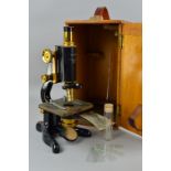 A CASED W. WATSON & SONS LTD LONDON 'SERVICE' MICROSCOPE, lacquered brass construction on a cast