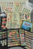 AN ACCUMULATION OF CHINESE STAMPS, in two stockbooks and loose with small Dragons used, also a
