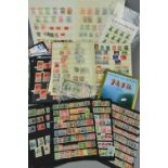 AN ACCUMULATION OF CHINESE STAMPS, in two stockbooks and loose with small Dragons used, also a