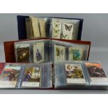 THREE POSTCARD ALBUMS, contents dating from the Victorian/Edwardian era to WWI and featuring cards