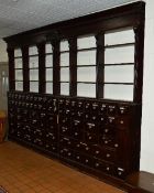 A VICTORIAN AND LATER MAHOGANY STAINED SET OF PHARMACISTS SHOP SHELVES AND DRAWERS, the cornice with