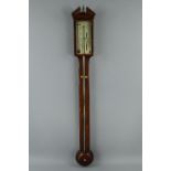 A GEORGE III MAHOGANY AND SATINWOOD BANDED STICK BAROMETER, brass urn finial between broken