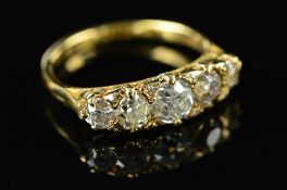 A LATE VICTORIAN DIAMOND CARVED HALF HOOP RING, five old cut diamonds graduating in size from 3.