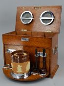 AN EARLY 20TH CENTURY OAK SMOKERS BOX, the hinged top opening to reveal two chrome ashtrays and