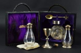 A GEORGE V TRAVELLING COMMUNION SET IN A FITTED CASE, comprising two glass bottles with silver screw