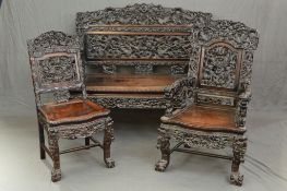 A LATE 19TH CENTURY STYLE ANGLO CHINESE CARVED HARDWOOD SEVEN PIECE SUITE, comprising four salon