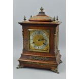 A LATE VICTORIAN OAK CASED BRACKET CLOCK, the architectural top with five finials, bevelled glass