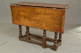 AN EARLY 18TH CENTURY OAK RECTANGULAR SINGLE DROP GATE LEG TABLE, moulded edge, on six bobbin and