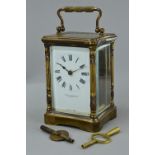 AN EARLY 20TH CENTURY FRENCH GILT BRASS CARRIAGE CLOCK, bevelled glass panels to the front, sides