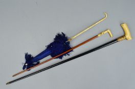 A LATE VICTORIAN LADIES BLUE SILK PARASOL, the folding bone handle carved with a dog's head tip, s.
