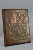 AN ARTS & CRAFTS COPPER MOUNTED ON WOOD 'GUEST BOOK', the embossed cover decorated with foliate