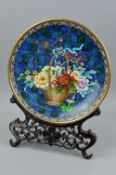 A 20TH CENTURY CLOISONNE CHARGER, blue floral ground with central basket of flowers, s.d., to the