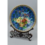 A 20TH CENTURY CLOISONNE CHARGER, blue floral ground with central basket of flowers, s.d., to the