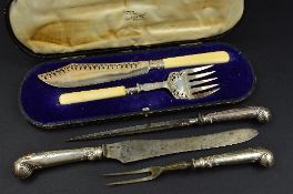 A CASED PAIR OF EDWARDIAN SILVER FISH SERVERS, with ivory handles, the blade and fork with pierced