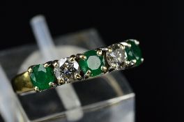 A MODERN 18CT GOLD EMERALD AND DIAMOND HALF ETERNITY RING, three round mixed cut emeralds