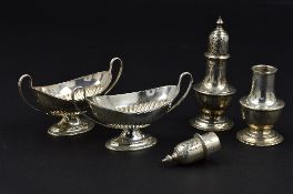 A PAIR OF VICTORIAN SILVER OVAL TWIN HANDLED SALTS, embossed reeding, oval foot, makers Harrison