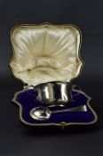 A CASED GEORGE V SILVER TWIN HANDLED PORRIDGE BOWL AND SPOON, makers Goldsmiths & Silversmiths