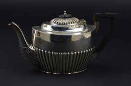 A VICTORIAN OVAL SILVER TEAPOT, reeded decoration, ebonised fitments, maker Samuel Walton Smith,