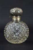 A LATE VICTORIAN SILVER MOUNTED HOBNAIL CUT SPHERICAL GLASS SCENT BOTTLE, hinged cover embossed with