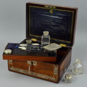 A VICTORIAN ROSEWOOD AND MOTHER OF PEARL INLAID DRESSING CASE, of rectangular form, the hinged cover
