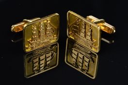A PAIR OF CUFFLINKS, square shape with an applied ship motif, hinged fitting, stamped '750',