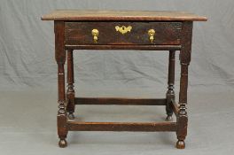A GEORGE III OAK SIDE TABLE, of rectangular form, the single frieze drawer with wavy brass