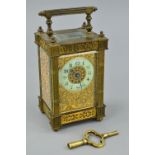 A LATE 19TH CENTURY GILT BRASS CARRIAGE CLOCK, the handle and four columns of square fluted