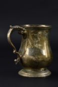 A GEORGE V SILVER TANKARD, of baluster form, foliate thumbpiece on a 'S' scroll handle, stepped