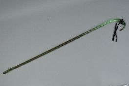 A 19TH CENTURY GLASS WALKING CANE, with textured spiral twist surface and dark red double air