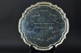 AN ELIZABETH II SILVER SALVER, pie crust edge, on four scrolled feet, engraved to the top with