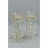 A PAIR OF LATE 19TH CENTURY CLEAR GLASS LUSTRES, the crenellated rims above vertical cut decoration,