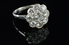 AN EARLY TO MID 20TH CENTURY DIAMOND ROUND CLUSTER RING, brilliant cut diamonds millegrain and