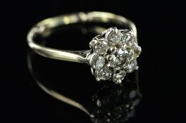 A MID 20TH CENTURY DIAMOND ROUND CLUSTER RING, estimated modern round brilliant cut weight 0.50ct,