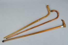 A VICTORIAN MALACCA WALKING CANE, the horn handle carved as an elephant's head, white metal band,