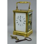 A FRENCH GILT BRASS CARRIAGE CLOCK, bevelled glass panels to the front, sides and door with an