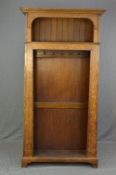 AN ARTS & CRAFTS OAK HALLSTAND, of pylon form, moulded cornice above a panelled back shelf, fitted