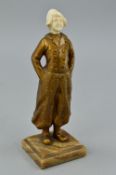 AN EARLY 20TH CENTURY PATINATED BRONZE AND IVORY FIGURE OF A DUTCH BOY, ivory head carved with small