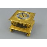 A 17TH CENTURY STYLE GILT METAL HORIZONTAL STRIKING AND REPEATING TABLE CLOCK, of square form,